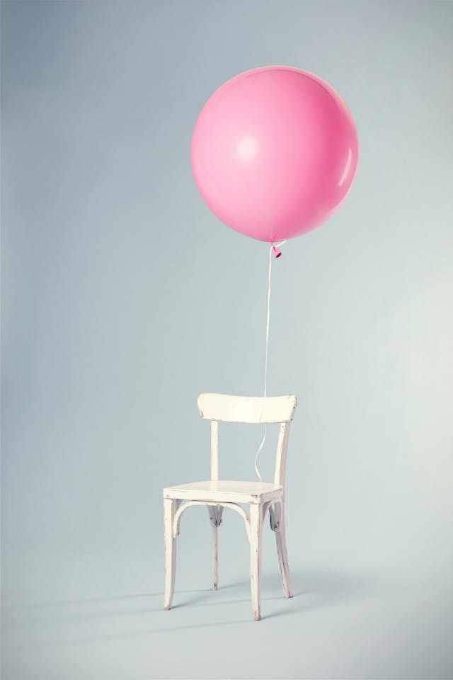 Floating Pink Balloon with Vintage Chair