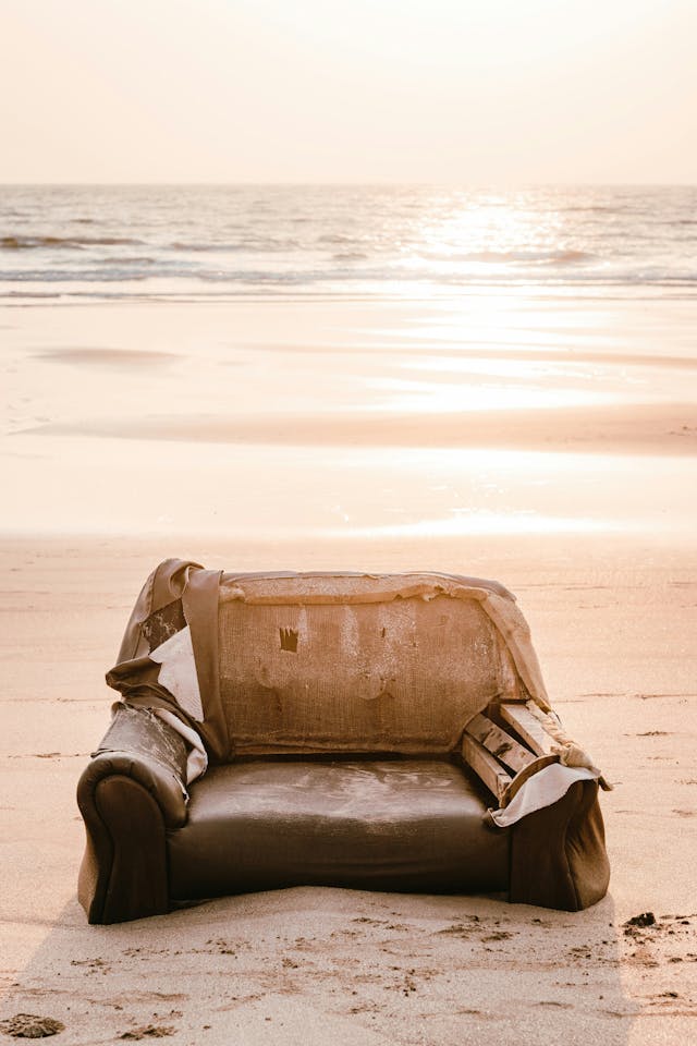 Worn Out Couch on a Beach at Sunset