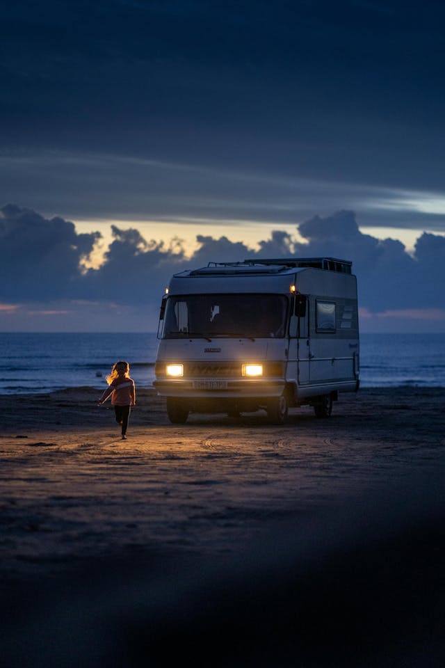 Child Running Towards Van by the Beach at Twilight